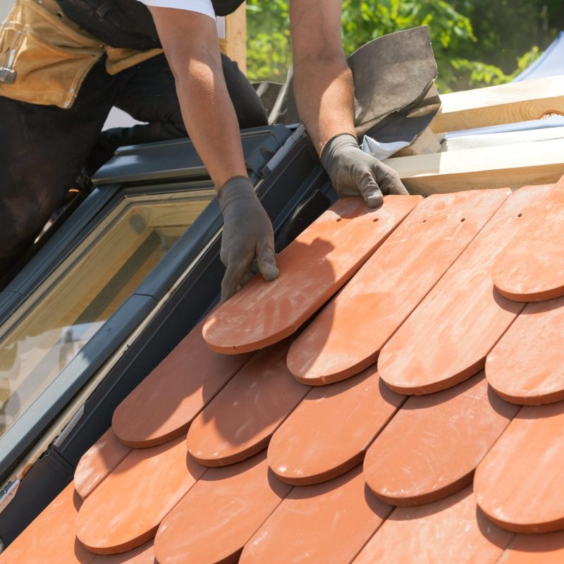 Hands,Of,Roofer,Laying,Tile,On,The,Roof.,Installing,Natural